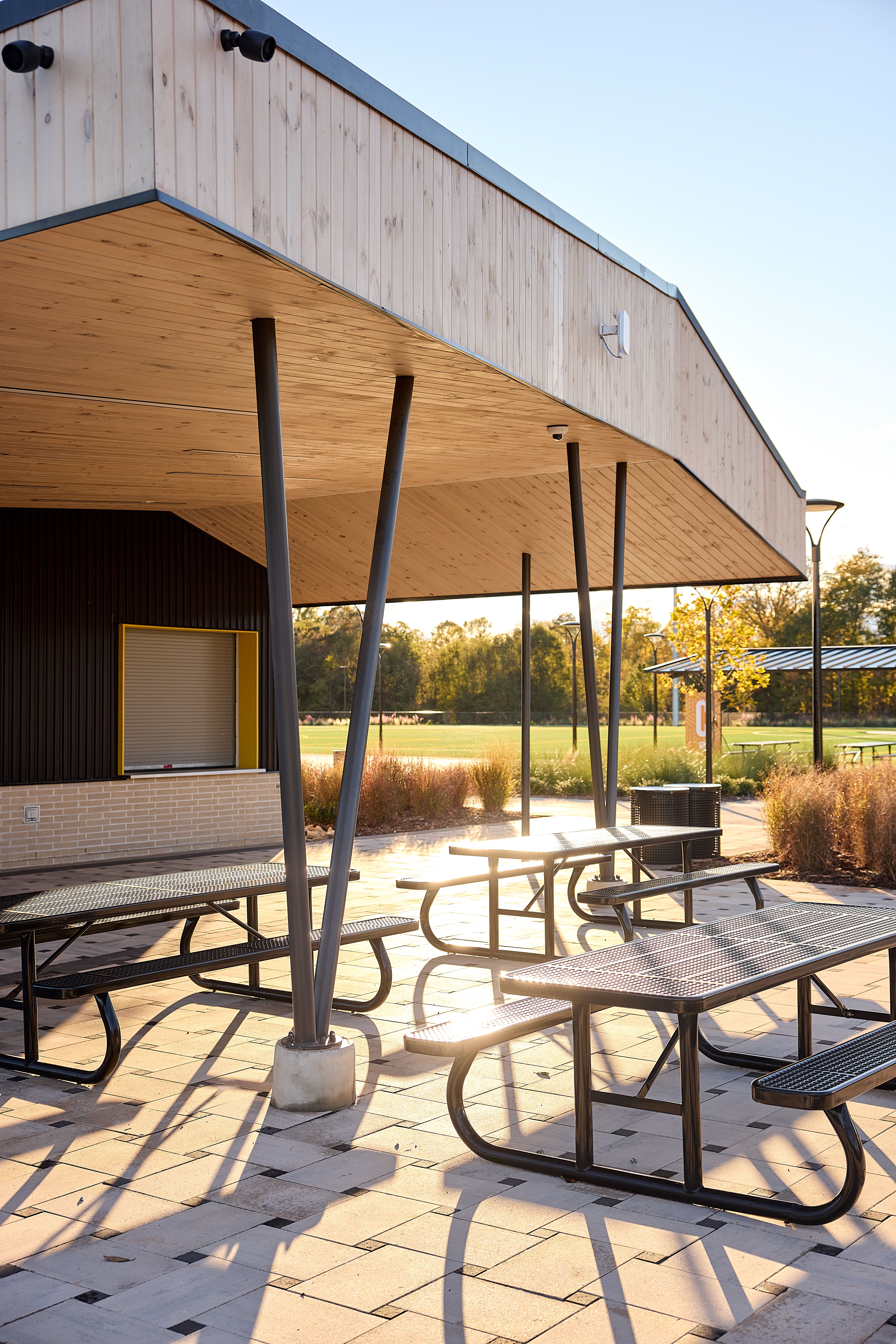 Closeup of outdoor picnic tables under a canopy