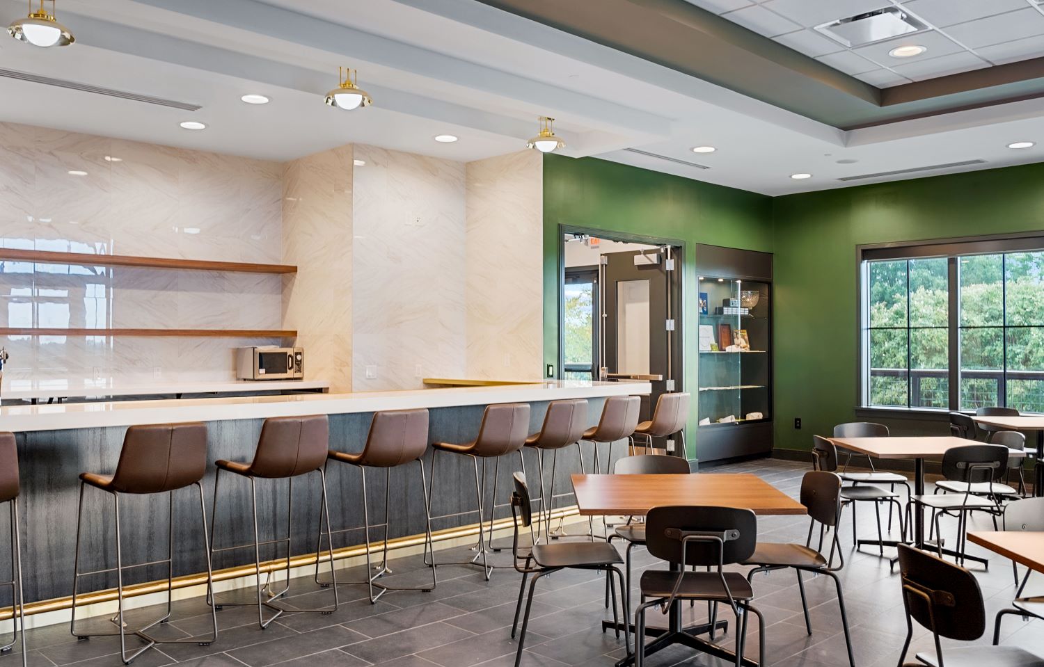 19th hole cafe with bar and several tables with chairs